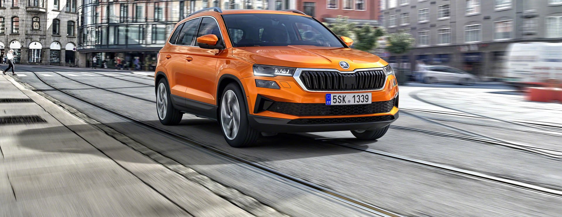 A Phoenix Orange Skoda Karoq driving